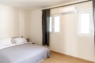 a bedroom with a white bed and two windows at Urban Athens - Two Bedroom #9 in Athens