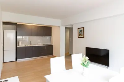 a living room with a large kitchen with a tv at Urban Athens - Two Bedroom #9 in Athens