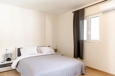 a bedroom with a white bed and a window at Urban Athens - Two Bedroom #9 in Athens