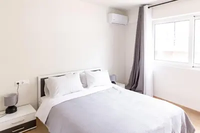 a bedroom with a white bed with a window at Urban Athens - Two Bedroom #9 in Athens