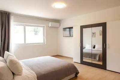 a bedroom with a bed and a window and a mirror at Urban Athens - Studio #10 in Athens