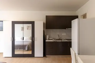 a room with a bed and a kitchen with a refrigerator at Urban Athens - Studio #10 in Athens