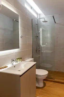 a bathroom with a sink and a toilet and a shower at Urban Athens - Studio #10 in Athens