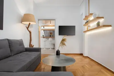 a living room with a couch and a table at Nostos Athens Luxury Residence in Athens
