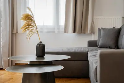 a vase on a table in a living room at Nostos Athens Luxury Residence in Athens