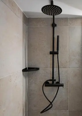 a shower with a black light in a bathroom at Nostos Athens Luxury Residence in Athens