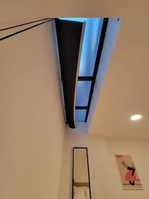 a skylight in the ceiling of a room with a ladder at ABIRA's Athens in Athens