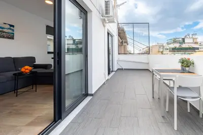 a balcony with a table and chairs on a building at ABIRA's Athens in Athens