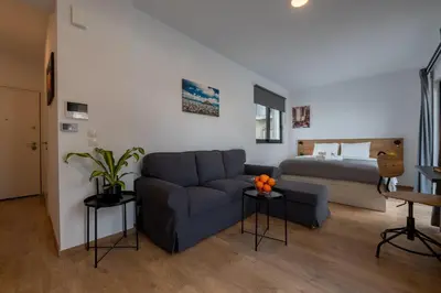 a living room with a couch and a bed at ABIRA's Athens in Athens