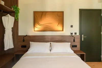 a bedroom with a bed and a painting on the wall at Ermou 26 Hotel in Athens