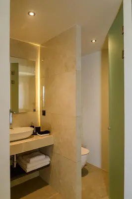 a bathroom with a sink and a mirror at Ermou 26 Hotel in Athens