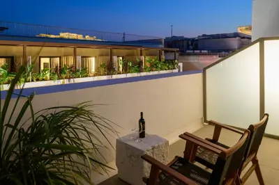 a balcony with a bottle of wine on a building at Ermou 26 Hotel in Athens