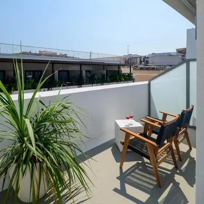 a balcony with two chairs and a table and a plant at Ermou 26 Hotel in Athens