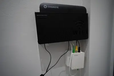 a black computer monitor hanging on a wall at Athens Loftnest in Athens