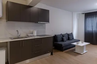a kitchen with a sink and a couch in a room at Urban Athens - One Bedroom #2 in Athens