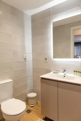 a bathroom with a toilet and a sink and a mirror at Urban Athens - One Bedroom #2 in Athens