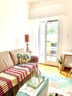 a living room with a couch and a table at Colorful Apartment Close to the Acropolis in Athens