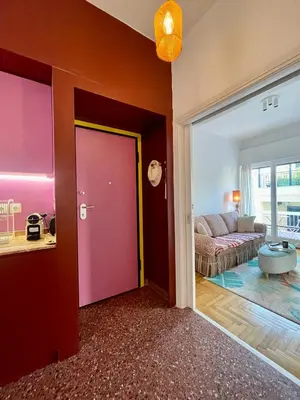 a living room with a red door and a couch at Colorful Apartment Close to the Acropolis in Athens