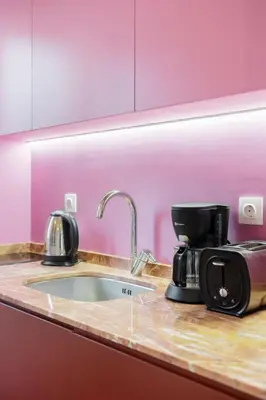 a kitchen counter with a sink and a coffee maker at Colorful Apartment Close to the Acropolis in Athens