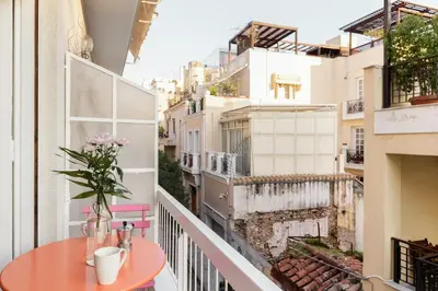 a balcony with a table and a view at Colorful Apartment Close to the Acropolis in Athens