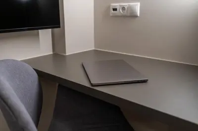 a desk in a room with a laptop on it at The Minion Elegant Suite Piraeus in Piraeus