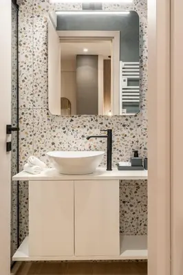 a bathroom with a sink and a mirror at The Minion Elegant Suite Piraeus in Piraeus