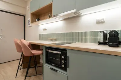 a kitchen with a counter and a stove top oven at The Minion Elegant Suite Piraeus in Piraeus