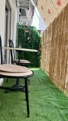 a room with a table and chairs and green grass at Yiayias home - Retro tranquility near Syntagma in Athens