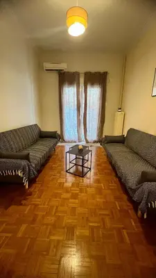 a living room with two couches and a table at Yiayias home - Retro tranquility near Syntagma in Athens