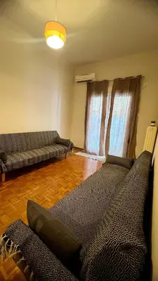 a living room with two couches and a couch at Yiayias home - Retro tranquility near Syntagma in Athens