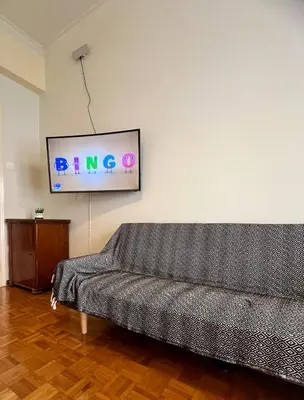 a living room with a couch and a flat screen tv at Yiayias home - Retro tranquility near Syntagma in Athens