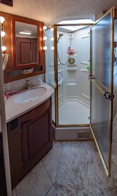 a bathroom with a shower and a sink at ATHENS MOTORHOME park RV WINNEBAGO in Pallíni
