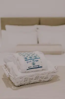 a stack of towels sitting on top of a basket at Suite Home Nikaia Metro! in Piraeus