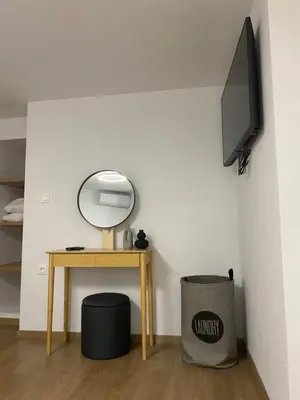 a room with a table with a mirror and a tv at Living Yard Acropolis Apartments in Athens