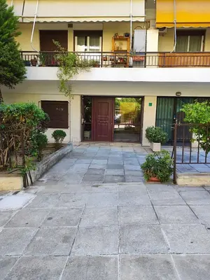 a building with a courtyard with a brown door at Center Athens all new and fully equipped 2 bedrooms 82 sqm big sea view apt close to Acropoli with Lift in Athens