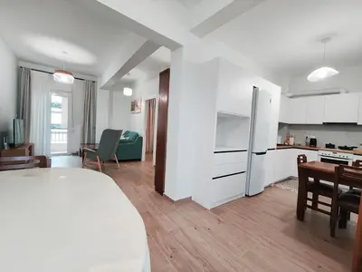 a kitchen and a living room with a bed and a table at Center Athens all new and fully equipped 2 bedrooms 82 sqm big sea view apt close to Acropoli with Lift in Athens