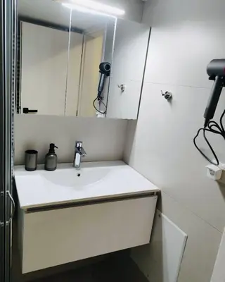 a white bathroom with a sink and a mirror at Center Athens all new and fully equipped 2 bedrooms 82 sqm big sea view apt close to Acropoli with Lift in Athens