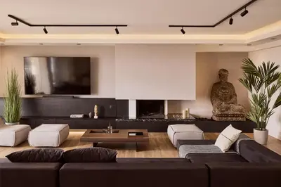 a living room with a black couch and a fireplace at Casa Volare, Penthouse Retreat - Athenian Riviera in Athens