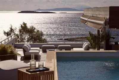 a swimming pool with a view of the water at Casa Volare, Penthouse Retreat - Athenian Riviera in Athens