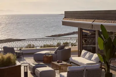 a patio with couches and a view of the ocean at Casa Volare, Penthouse Retreat - Athenian Riviera in Athens