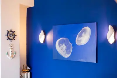 a blue wall with a picture of two babies at TheJellyfishDream Sea-view Balcony Piraeus Escape in Piraeus