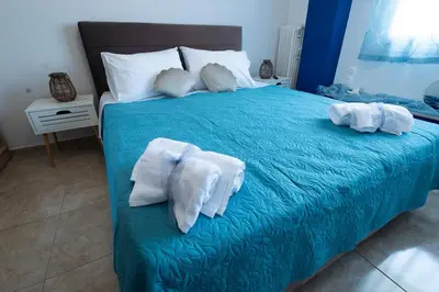 a bedroom with a blue bed with towels on it at TheJellyfishDream Sea-view Balcony Piraeus Escape in Piraeus