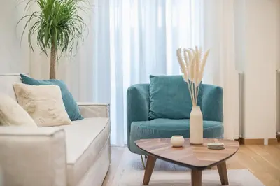 a living room with a couch and a table at Acropolis Luxurious Apartment in Athens