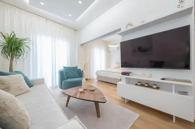a living room with a large flat screen tv at Acropolis Luxurious Apartment in Athens