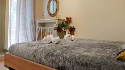 a bedroom with a bed with towels on it at The Athenian Nook in Athens