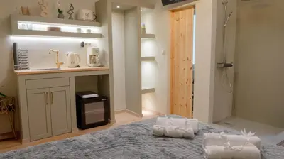a bathroom with a bed and a sink in a room at The Athenian Nook in Athens