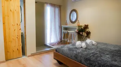 a bedroom with a bed with white shoes on it at The Athenian Nook in Athens