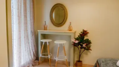 a room with two stools and a mirror on the wall at The Athenian Nook in Athens