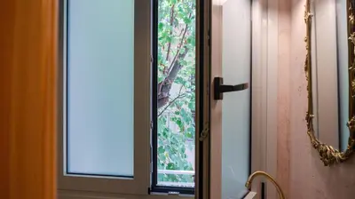 a bathroom door with a window in a bathroom at The Athenian Nook in Athens
