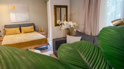 a living room with a bed and a couch at The Clay Nest in Athens